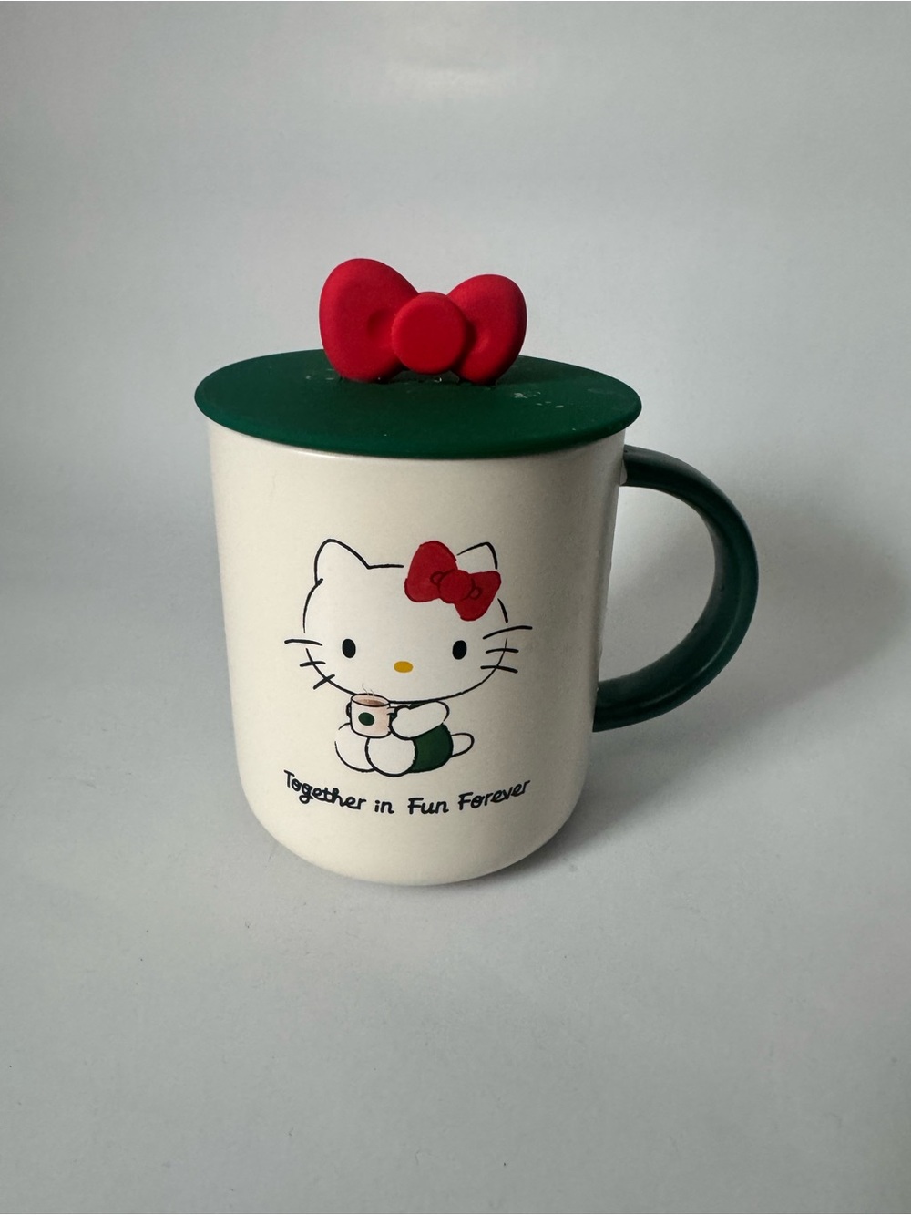 Starbucks White Ceramic Hello Kitty Mug with Green Lid, Handle and Red Bow